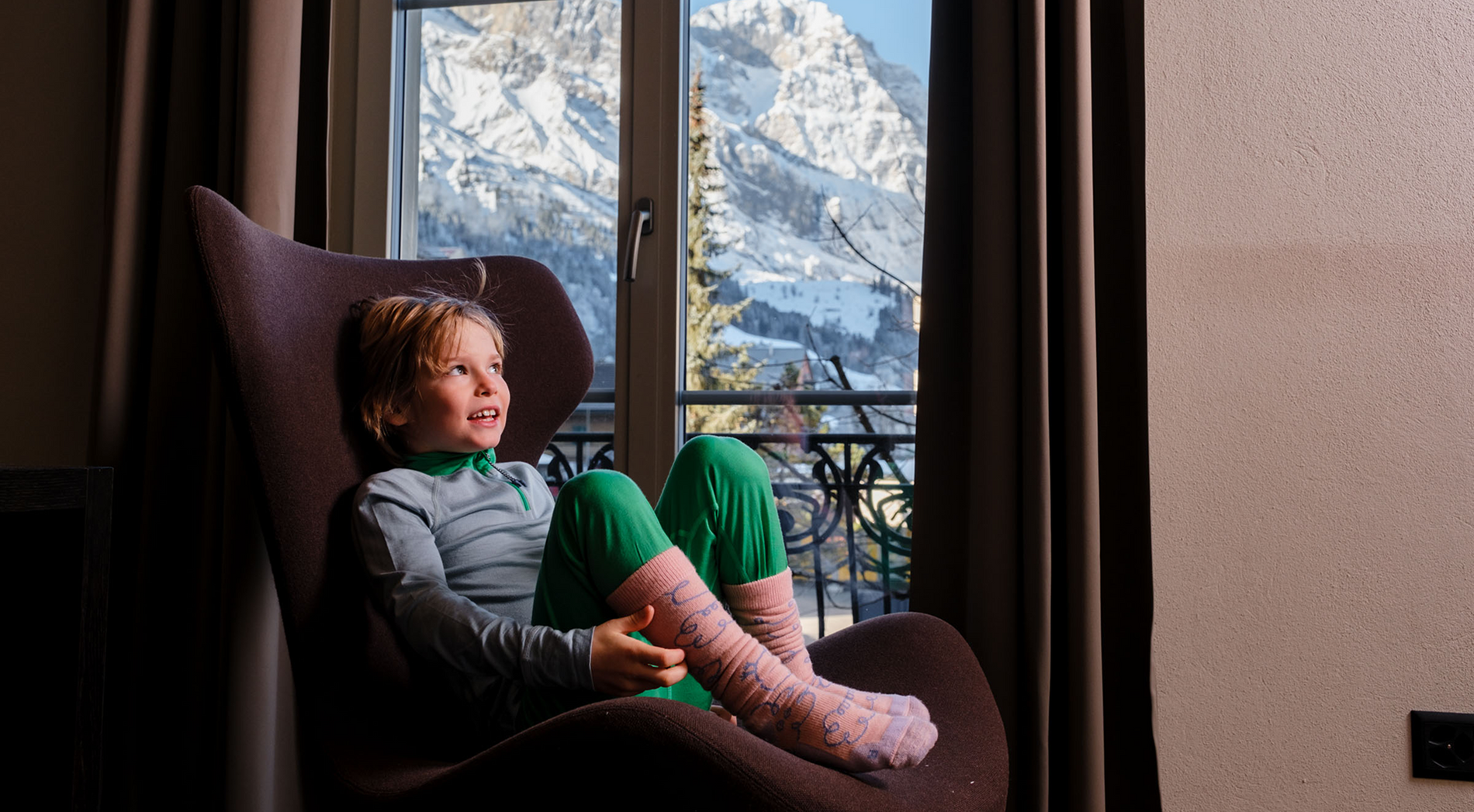 Kind mit namuk Merino-Bekleidung sieht aus dem Fenster